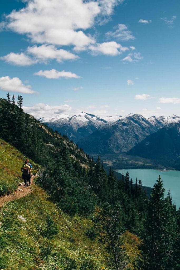 Hiker on a trail with mountains